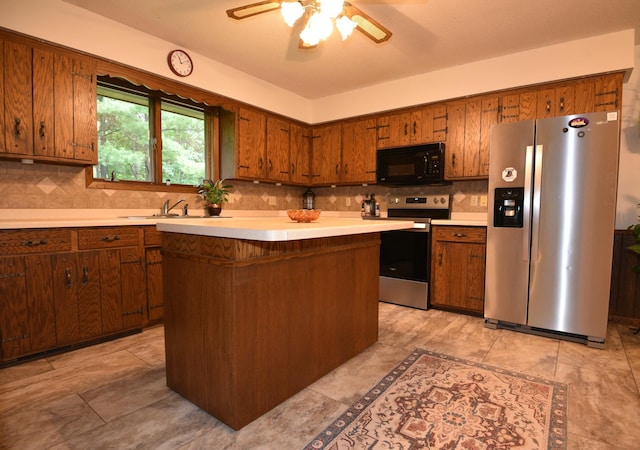 22761 105th Ave, Milaca, MN 56353 - kitchen featuring appliances with stainless steel finishes, light countertops, a ceiling fan, decorative backsplash, and brown cabinets
