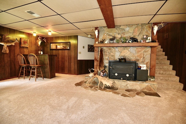 22761 105th Ave, Milaca, MN 56353 - carpeted living area featuring wood walls, a paneled ceiling, a bar, and stairway