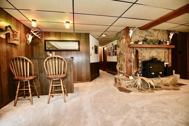 22761 105th Ave, Milaca, MN 56353 - bar featuring wood walls, carpet, and a wood stove