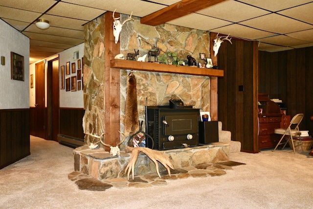 22761 105th Ave, Milaca, MN 56353 - carpeted living room with wood walls, a drop ceiling, a baseboard heating unit, and wainscoting