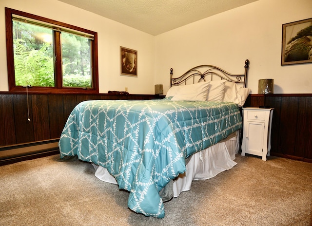 22761 105th Ave, Milaca, MN 56353 - bedroom featuring carpet flooring, a baseboard radiator, and a textured ceiling