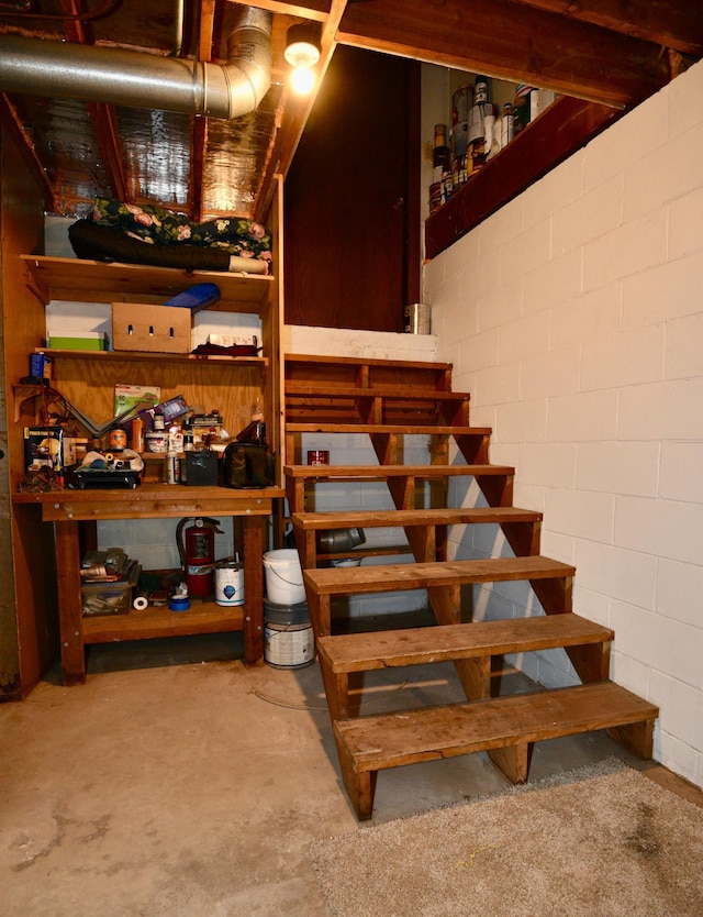 22761 105th Ave, Milaca, MN 56353 - stairway featuring concrete block wall and unfinished concrete flooring