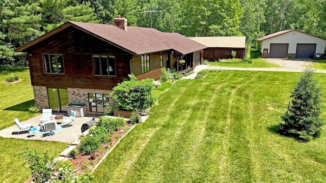 22761 105th Ave, Milaca, MN 56353 - rear view of house with a patio area, a lawn, a chimney, a detached garage, and an outdoor structure