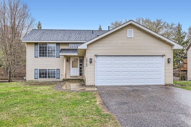 12740 Eveleth Path, Apple Valley, MN 55124 - split level home featuring asphalt driveway, roof with shingles, a front yard, and a garage