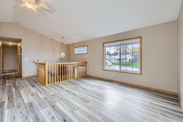 12740 Eveleth Path, Apple Valley, MN 55124 - unfurnished room featuring lofted ceiling, wood finished floors, and ceiling fan