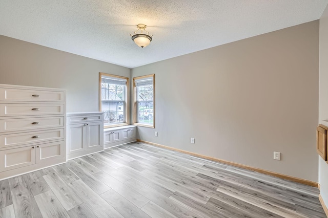 12740 Eveleth Path, Apple Valley, MN 55124 - unfurnished room with light wood-style floors and a textured ceiling