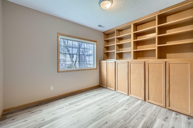 12740 Eveleth Path, Apple Valley, MN 55124 - empty room with a textured ceiling and light wood-style flooring