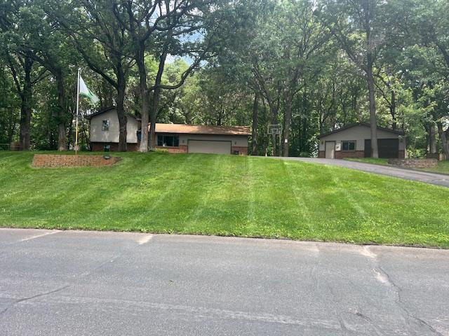 13301 Oak Ridge Rd, Zimmerman, MN 55398 - view of front of home featuring an attached garage, a front yard, driveway, and view of scattered trees
