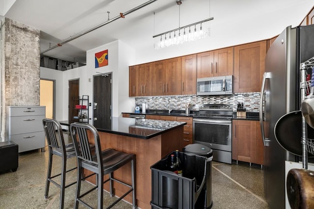 350 Saint Peter St Unit 707, Saint Paul, MN 55102 - kitchen with appliances with stainless steel finishes, dark countertops, decorative backsplash, a kitchen bar, and a towering ceiling
