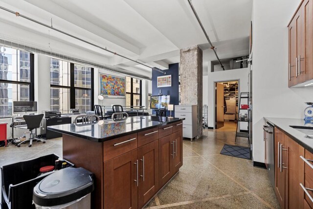 350 Saint Peter St Unit 707, Saint Paul, MN 55102 - kitchen featuring plenty of natural light, speckle patterned floor, an office area, and dark stone counters