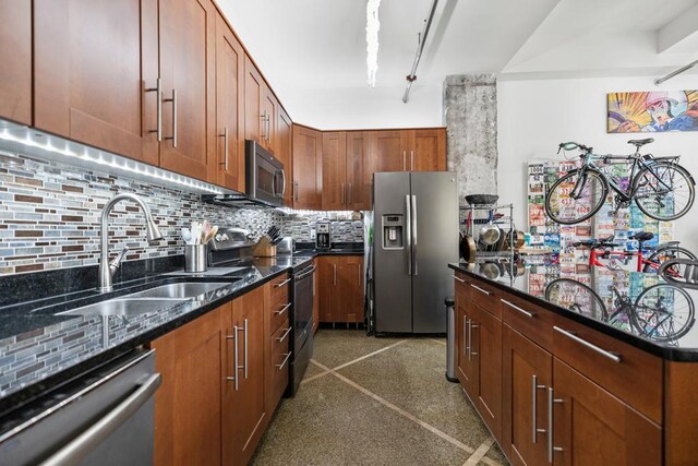 350 Saint Peter St Unit 707, Saint Paul, MN 55102 - kitchen with appliances with stainless steel finishes, tasteful backsplash, dark stone countertops, brown cabinetry, and a center island