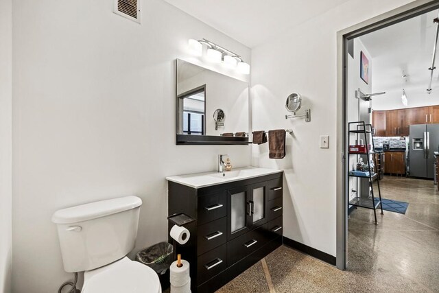 350 Saint Peter St Unit 707, Saint Paul, MN 55102 - bathroom featuring vanity, backsplash, and speckled floor