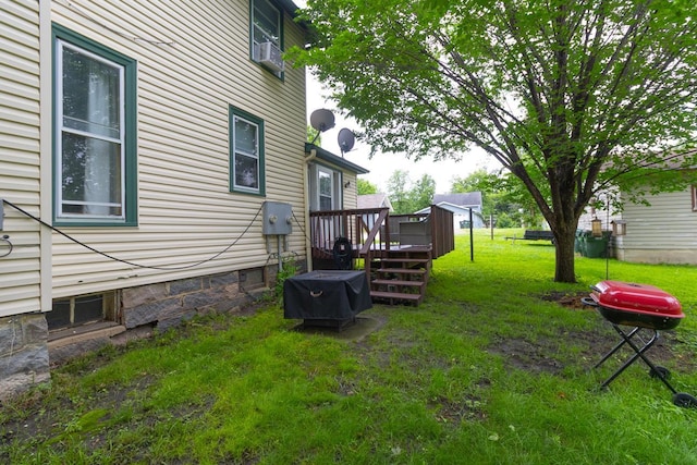 310 4th Ave SW, Hutchinson, MN 55350 - view of grassy yard with a wooden deck and cooling unit