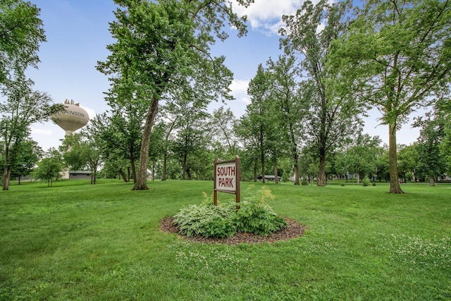 310 4th Ave SW, Hutchinson, MN 55350 - view of green lawn featuring view of wooded area