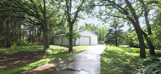 5430 155th Ln NW, Ramsey, MN 55303 - view of grassy yard featuring an outdoor structure, a detached garage, and concrete driveway