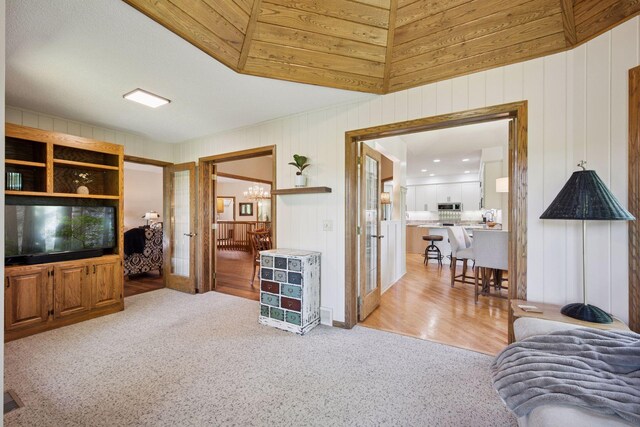 5625 Zachary Ln N, Plymouth, MN 55442 - carpeted living area featuring a chandelier, french doors, and wood walls