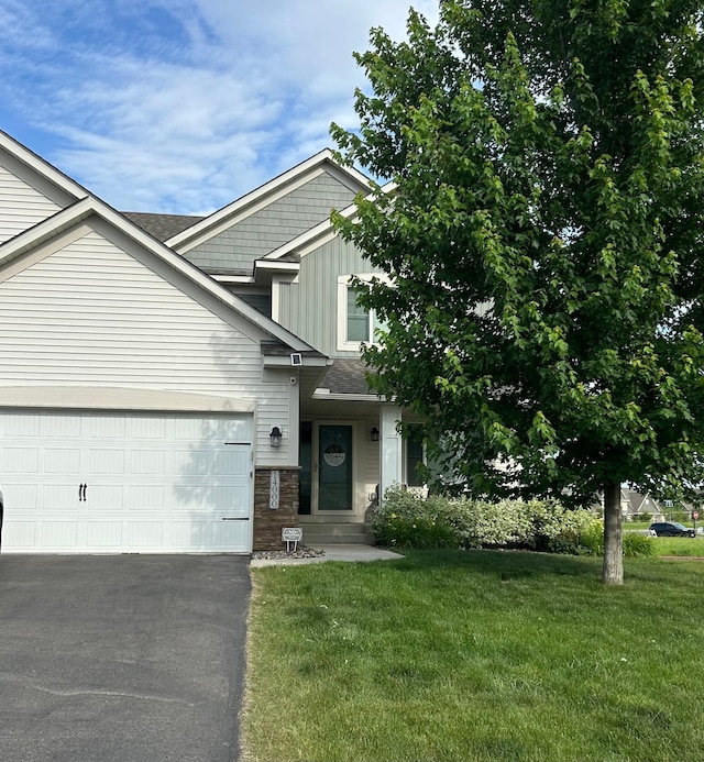 14000 Ashford Path, Rosemount, MN 55068 - view of front facade with a front lawn, driveway, an attached garage, and board and batten siding