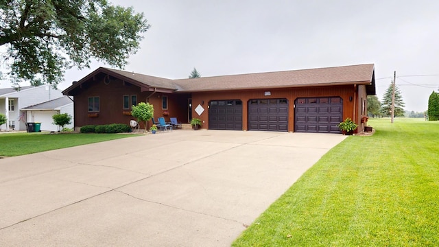 2017 Highland Ave, Albert Lea, MN 56007 - view of front of home featuring a garage, a front yard, and driveway