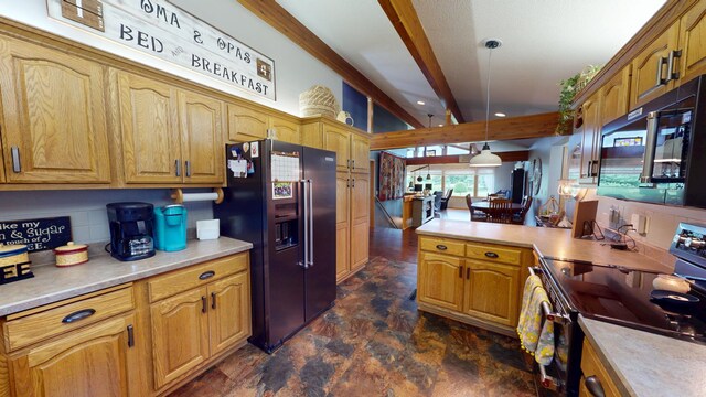 2017 Highland Ave, Albert Lea, MN 56007 - kitchen with black appliances, stone finish flooring, beam ceiling, light countertops, and pendant lighting