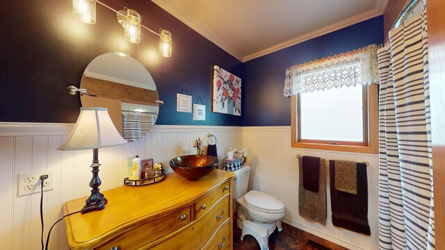 2017 Highland Ave, Albert Lea, MN 56007 - bathroom with a wainscoted wall, crown molding, and vanity