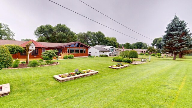 2017 Highland Ave, Albert Lea, MN 56007 - view of green lawn featuring a vegetable garden