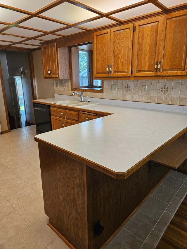 5306 Boulder Ln, Brooklyn Center, MN 55429 - kitchen featuring dishwasher, light countertops, brown cabinets, and decorative backsplash