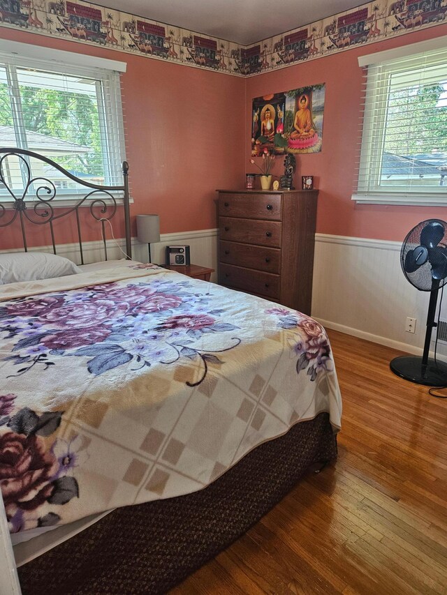 5306 Boulder Ln, Brooklyn Center, MN 55429 - bedroom featuring wood finished floors and a wainscoted wall