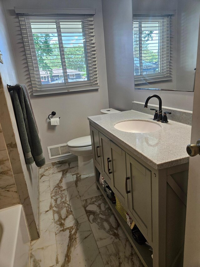 5306 Boulder Ln, Brooklyn Center, MN 55429 - bathroom featuring marble finish flooring, vanity, and healthy amount of natural light