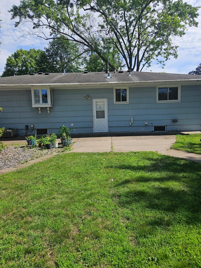 5306 Boulder Ln, Brooklyn Center, MN 55429 - back of property featuring a patio and a lawn