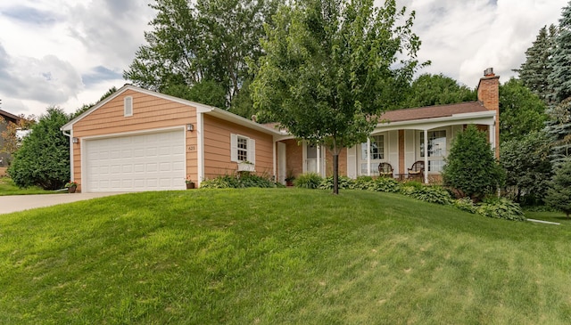 625 Folwell Ln SW, Rochester, MN 55902 - ranch-style house featuring a chimney, a front yard, driveway, an attached garage, and covered porch