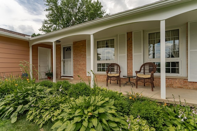 625 Folwell Ln SW, Rochester, MN 55902 - doorway to property featuring covered porch and brick siding