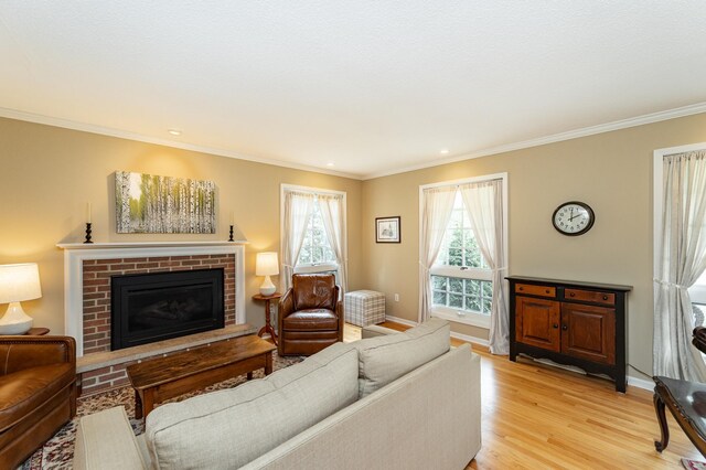 625 Folwell Ln SW, Rochester, MN 55902 - living area featuring light wood-style floors, a brick fireplace, ornamental molding, and recessed lighting