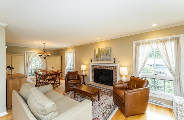 625 Folwell Ln SW, Rochester, MN 55902 - living area featuring a chandelier, light wood-type flooring, a fireplace, crown molding, and recessed lighting
