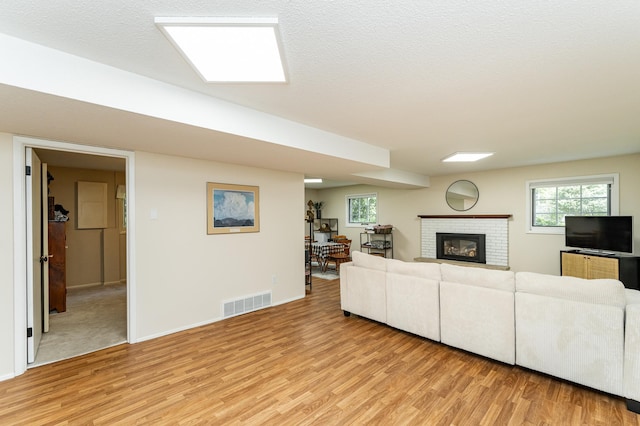 625 Folwell Ln SW, Rochester, MN 55902 - living area with light wood-type flooring, a fireplace, and plenty of natural light