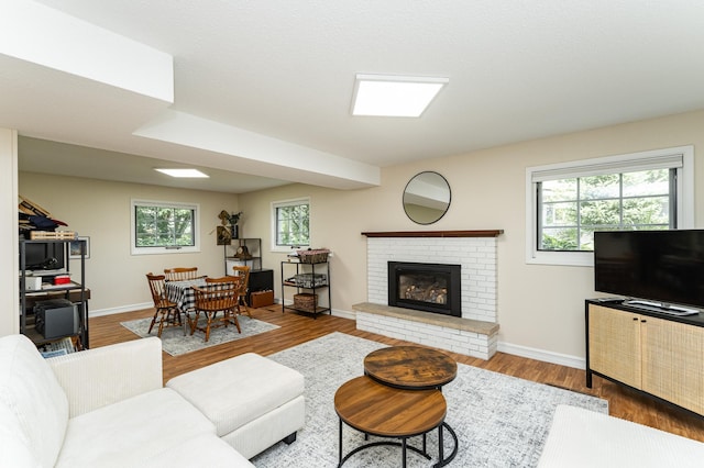 625 Folwell Ln SW, Rochester, MN 55902 - living room featuring healthy amount of natural light, a fireplace, and wood finished floors