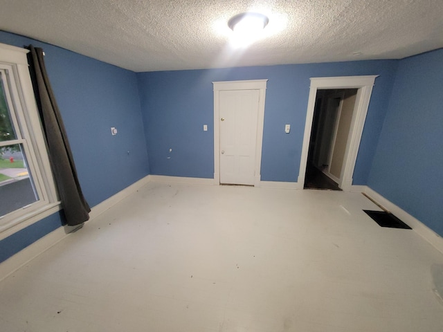 302 3rd St W, Hastings, MN 55033 - unfurnished bedroom featuring a textured ceiling and baseboards
