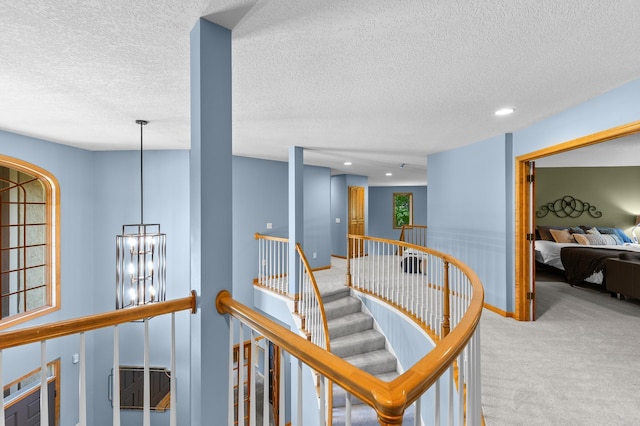 6354 Oxbow Bnd, Chanhassen, MN 55317 - hall with carpet floors, a chandelier, an upstairs landing, a textured ceiling, and recessed lighting