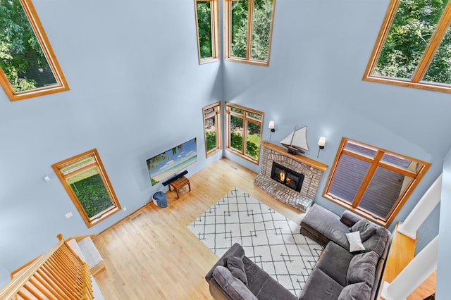 6354 Oxbow Bnd, Chanhassen, MN 55317 - living room featuring a towering ceiling, a fireplace, plenty of natural light, and wood finished floors