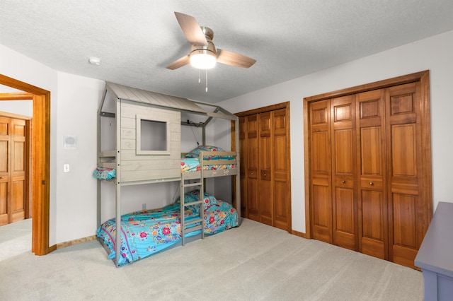 6354 Oxbow Bnd, Chanhassen, MN 55317 - carpeted bedroom featuring two closets, a textured ceiling, and ceiling fan