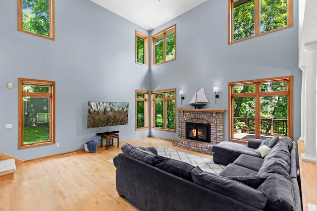 6354 Oxbow Bnd, Chanhassen, MN 55317 - living room with a high ceiling, wood finished floors, a fireplace, and decorative columns