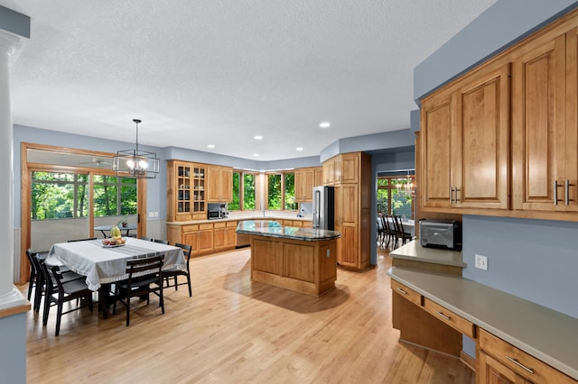 6354 Oxbow Bnd, Chanhassen, MN 55317 - kitchen with freestanding refrigerator, a kitchen island, recessed lighting, light wood-type flooring, and a textured ceiling