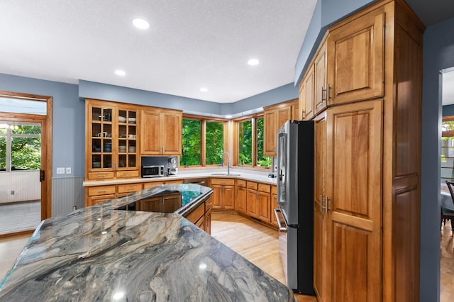 6354 Oxbow Bnd, Chanhassen, MN 55317 - kitchen with appliances with stainless steel finishes, healthy amount of natural light, light wood-type flooring, glass insert cabinets, and recessed lighting