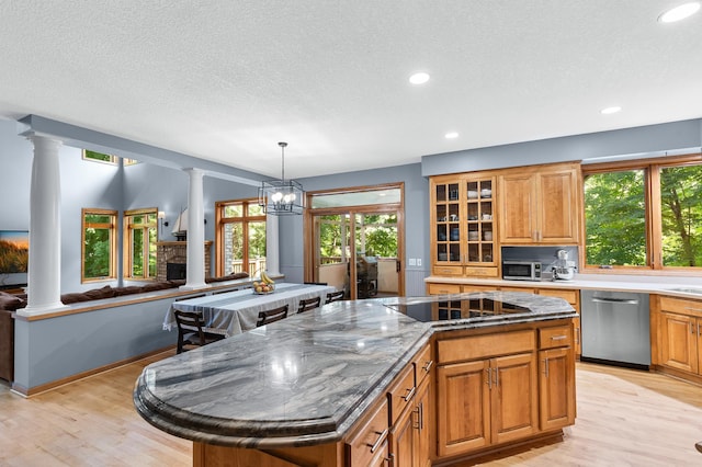 6354 Oxbow Bnd, Chanhassen, MN 55317 - kitchen featuring appliances with stainless steel finishes, ornate columns, a kitchen island, light wood-type flooring, and a textured ceiling