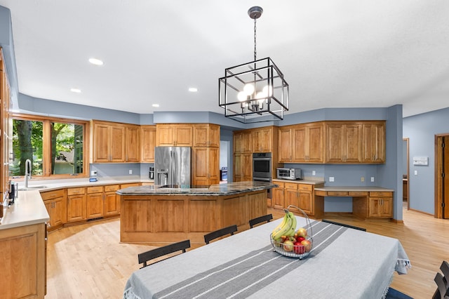 6354 Oxbow Bnd, Chanhassen, MN 55317 - kitchen with stainless steel appliances, a kitchen island, light wood-type flooring, a chandelier, and recessed lighting