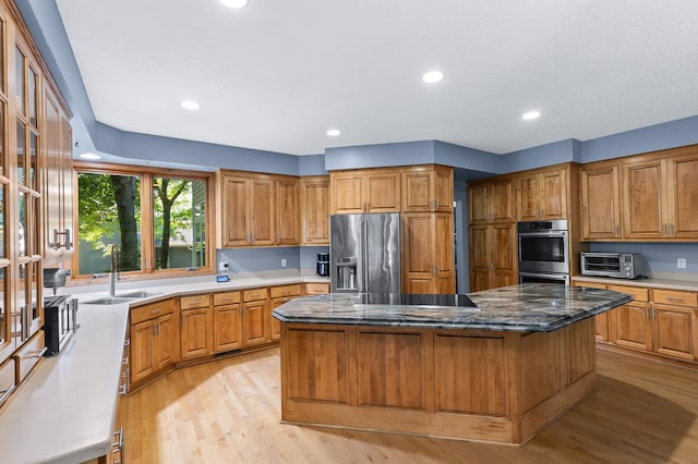 6354 Oxbow Bnd, Chanhassen, MN 55317 - kitchen with stainless steel appliances, a kitchen island, light wood finished floors, brown cabinetry, and recessed lighting