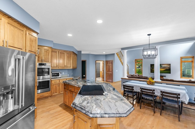 6354 Oxbow Bnd, Chanhassen, MN 55317 - kitchen featuring stainless steel appliances, a kitchen island, light wood-style flooring, open floor plan, and a chandelier
