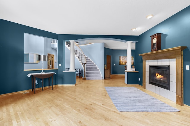 6354 Oxbow Bnd, Chanhassen, MN 55317 - living room featuring ornate columns, wood finished floors, a fireplace, and stairs