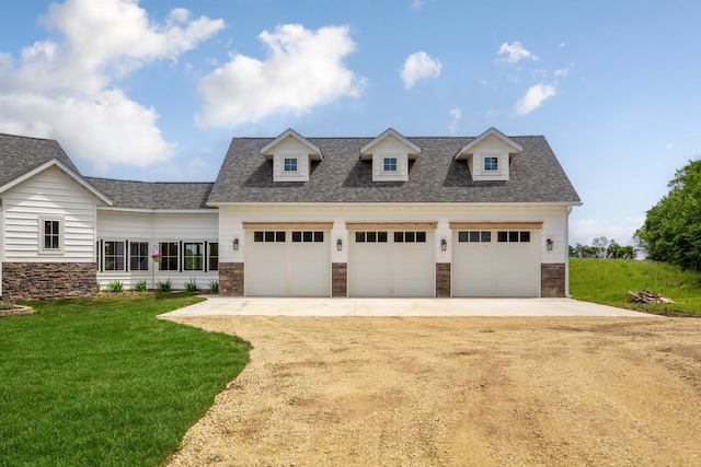 13827 Halstad Ave, Lonsdale, MN 55046 - view of front of house with stone siding, a front yard, roof with shingles, and driveway