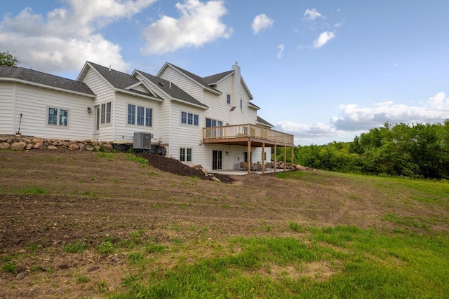 13827 Halstad Ave, Lonsdale, MN 55046 - back of house with a wooden deck, a chimney, a patio, and a shingled roof