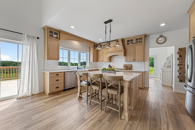 13827 Halstad Ave, Lonsdale, MN 55046 - kitchen with stainless steel appliances, light countertops, light wood-style floors, a breakfast bar, and a center island